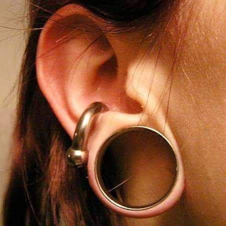 a close up of a person's ear with an object in the middle of it