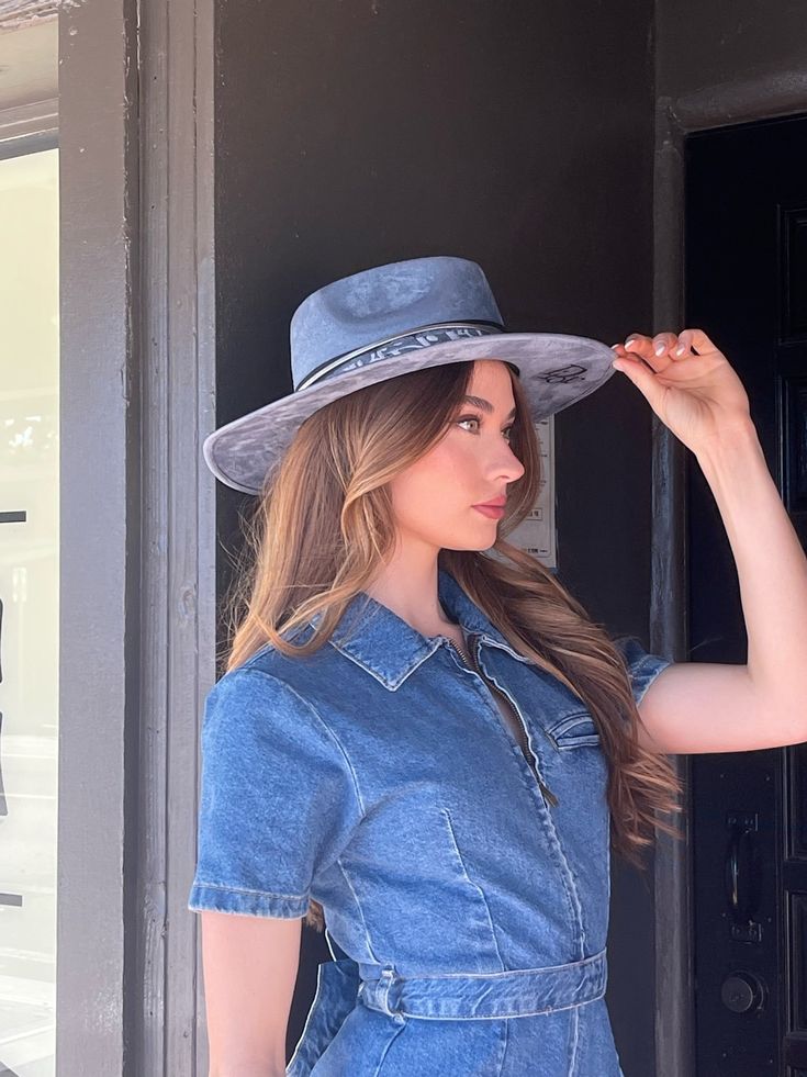 Our love of hats continues with this incredible handmade original: meet the Luxe Banded Hat in denim blue. A hat this good needs to be worn as much as possible and with every single outfit! Hand made by artisans, incredible quality, pure suede, genuine leather trim around the crown, iconic trim, the list goes on! Will ship 12/1. The best part? It's super structured with an elastic band on the inside that will fit EVERYONE. Btw never taking this hat off. These hats are a limited edition. THE HAT:-Rancher style hat, pure suede-Stiff brim with elastic hat band on the inside-- OMG YES-Classic, iconic denim blue-Genuine leather trim and chain-- talk about luxe-Incredible quality-Holds it's shape amazingly 22.5 inches 3.5 inch brim // 4 inch crown100% suede Curved Brim Denim Blue Hat, Blue Fedora Country Style Hat, Denim Blue Hat With Curved Brim, Blue Country Fedora Hat, Denim Blue Curved Brim Hat, Blue Short Brim Country Hat, Blue Country Hat With Short Brim, Blue Country Style Fedora Hat, Dark Wash Denim Hat With Curved Brim