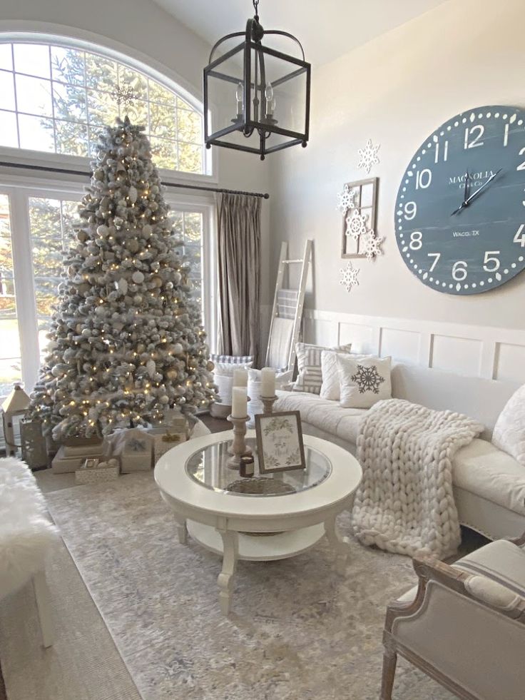 a living room decorated for christmas with a large clock on the wall above the coffee table