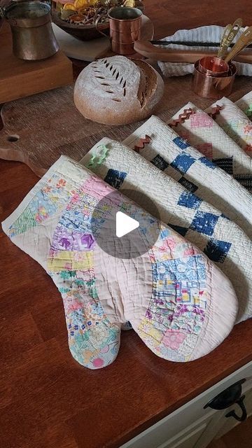 an elephant made out of quilts sitting on top of a wooden table next to other items