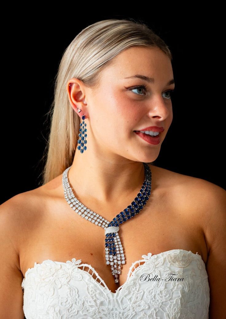 BELLA TIARA INTRODUCES OUR ROYAL JEWELRY COLLECTION Every piece is made to perfection, we only use the finest CZ diamond like cubic zirconia for that dazzling and dramatic look and always at a fraction of the price of any bridal boutique. gorgeous!!! a heirloom statement jewelry set created for the woman who loves to make an entrance. Measures approximately 16"L - fold-over and locked clasp 2 1/4" drop pierced back earrings 14k white gold electroplated Elegant tennis bracelet sold separately --- White Crystal Bridal Sets For Party, Party Bridal Necklace In White Gold With Sparkling Stones, Diamond White Bridal Necklace For Party, Diamond White Bridal Necklace With Diamond Accents For Party, Evening Jewelry With Sparkling Stones In Diamond White, Diamond White Sparkling Stones Jewelry For Evening, Diamond White Jewelry With Sparkling Stones For Evening, White Cubic Zirconia Jewelry Sets For Party, Evening White Gold Crystal Jewelry