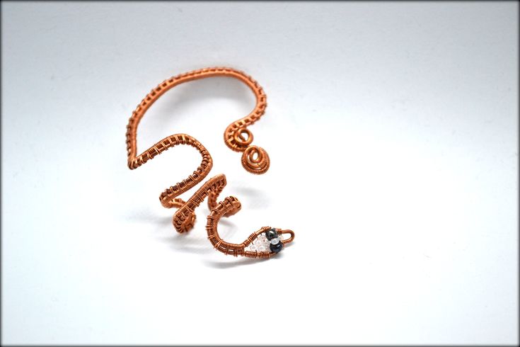 Snake Ear Wrap/No piercing Ear Cuff/Reptile Ear Cuff/Ear wrap/Snake Earring/Wire Wrapped Ear Cuff/Raw Copper Ear Cuff/Boho Ear Cuff/Gift For Her ❤️ Wire wrapped snake ear wrap. No piercing required! It's made of raw copper wires and seed beads and you have the option to choose between the natural copper color or oxidized copper color. The eyes of the snake are dark blue and the rest of the head is light blue seed beeds. Almost any other colors available. Just message me! ★ PLEASE READ THE BELOW: Adjustable Bohemian Ear Climbers As A Gift, Bohemian Adjustable Ear Climbers For Gift, Adjustable Bohemian Ear Climbers For Gift, Bohemian Adjustable Ear Climbers, Adjustable Spiral Ear Cuff, Adjustable Metal Ear Climbers As Gift, Adjustable Metal Ear Climbers Gift, Wire Wrapped Metal Ear Cuff As Gift, Unique Adjustable Spiral Wrap Earrings