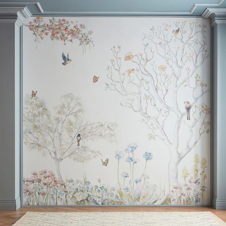 the wall is painted with birds and flowers in an empty room next to a rug