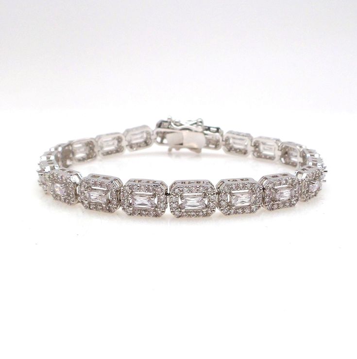 a white gold bracelet with baguetts and diamonds on the clasp, set in 18k white gold