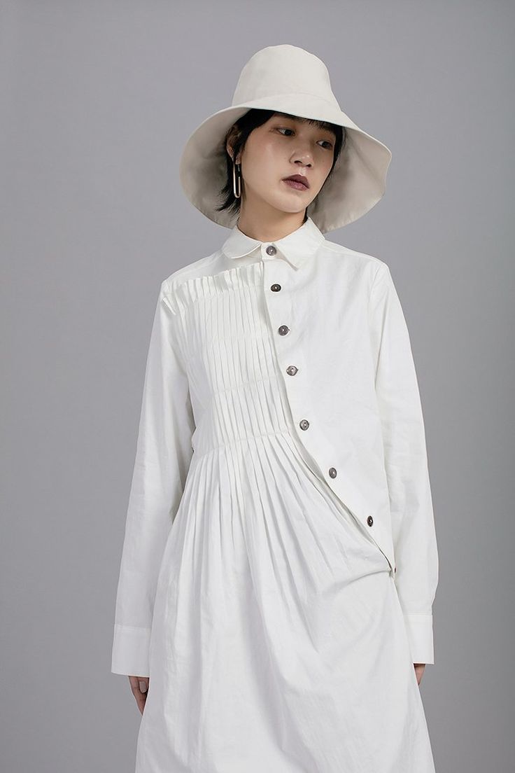 Asymmetric Folding Curved Pleated Middle Long Shirt Tunic – Ofelya Boutique Casual Pleated Relaxed Fit Blouse, Spring Tops With Buttons And Asymmetrical Hem, Spring Tops With Asymmetrical Hem And Buttons, Pleated Long Sleeve Top For Summer, Summer Long Sleeve Pleated Top, Spring Pleated Button-up Tops, Casual Collared Pleated Tops, Casual Pleated Collared Blouse, Spring Pleated Collared Blouse