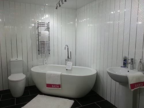 a white bath tub sitting next to a toilet