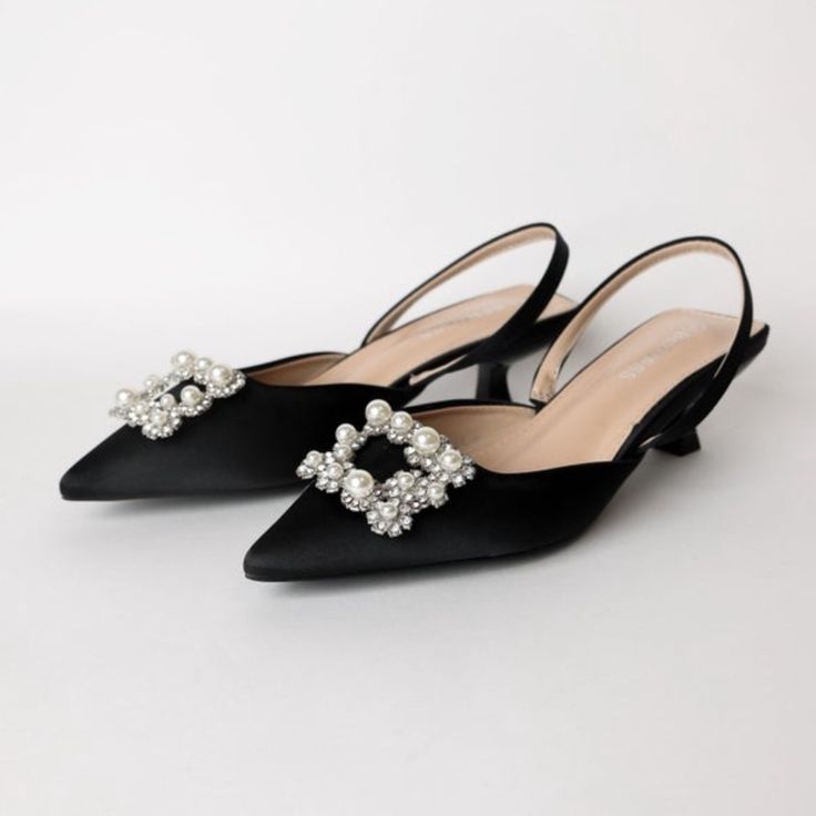 Pearl Sling Slide Mini Heel Features: Rhinestones, Pearls, Heel Height Of Heel (If Any): .5" Brand: Berness Black High Heel Slingback Pumps For Wedding, Black Slingback Pumps With Heel Strap For Wedding, Black Slingback Pumps For Wedding With Heel Strap, Black Slingback Pumps For Summer Wedding, Black Slingback Pumps For Wedding, Black Slingback Heels For Events, Black Slingback Heels For Wedding, Embellished Black Slingback Pumps For Formal Occasions, Chic Black Slingback Pumps For Wedding