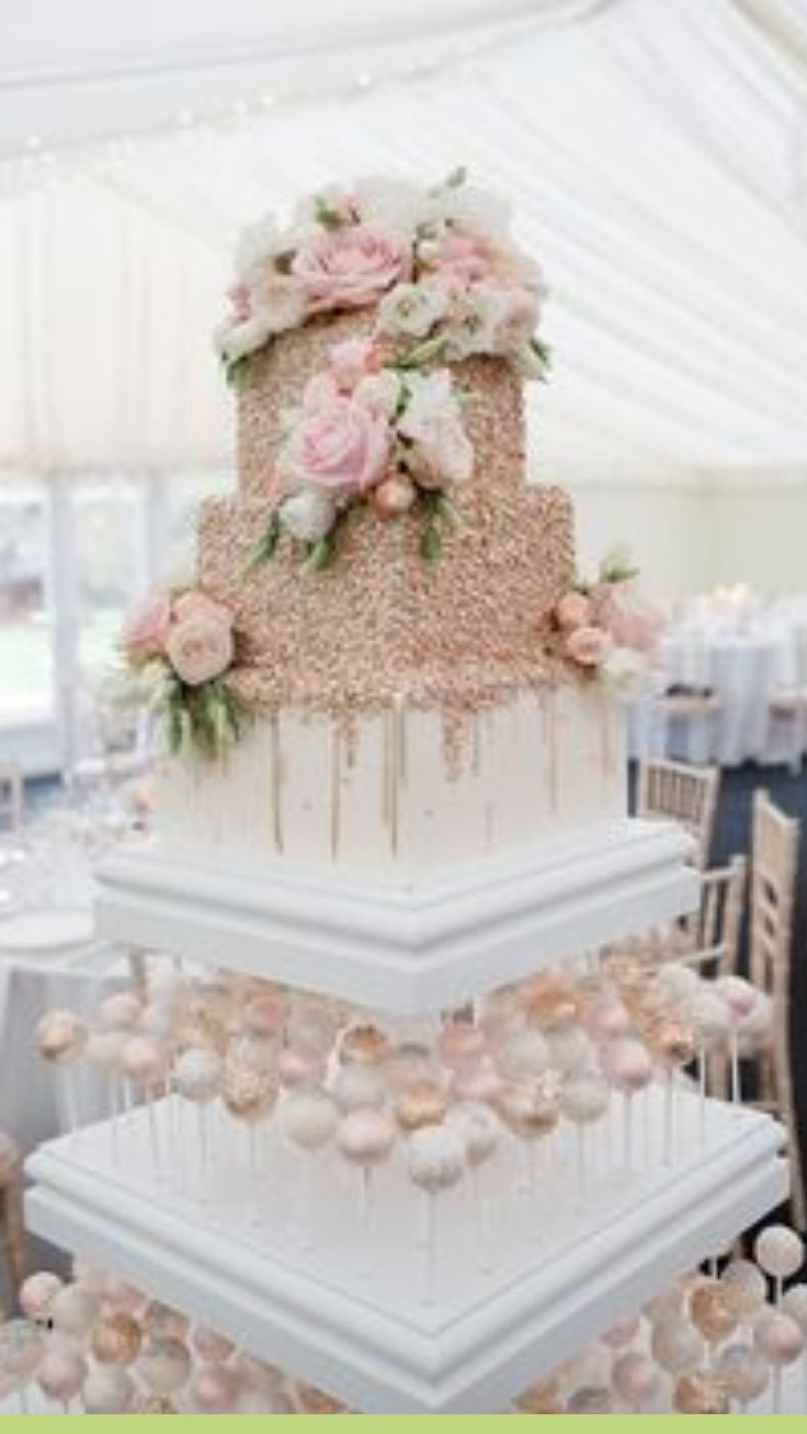 a three tiered wedding cake with pink flowers on top