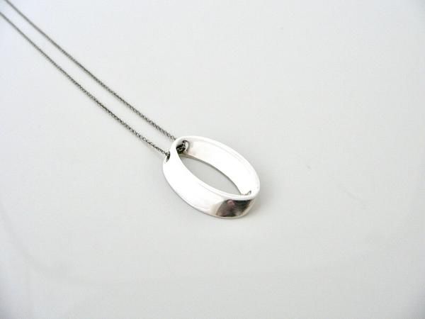 Overview: Offered  for sale is a wonderful Tiffany classic.   Whether you are just  starting your Tiffany collection or are thinking of adding another  piece, this one is perfect for you.  Tiffany & Co.'s Sterling Silver Geometric Oval necklace is a Tiffany classic that will never  go out of style. It will most certainly be a piece that you will turn to  over and over again, so it is great value for your money!  It is a  wonderful necklace that fits a lifestyle on the go -- the necklace can Oval Link Necklace With Polished Finish As Gift, Contemporary Oval Jewelry With Polished Finish, Everyday Oval Necklace With Polished Finish, Modern Oval Necklace With Polished Finish, Silver Oval Necklace For Everyday, Everyday Silver Oval Necklace, Modern Oval Sterling Silver Necklace, Contemporary Necklace With Polished Finish As Gift, Contemporary Polished Finish Necklace For Gift