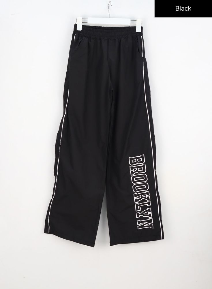 Black / S/M Sporty Relaxed Fit Pants With Logo Print, Black Relaxed Fit Bottoms With Logo Print, Casual Relaxed Fit Sweatpants With Logo Print, Casual Pants With Logo Print For Loungewear, Athleisure Streetwear Pants With Logo Print, Black Cotton Pants With Logo Print, Cotton Logo Print Bottoms For Streetwear, Cotton Bottoms With Logo Print For Streetwear, Cotton Streetwear Bottoms With Logo Print