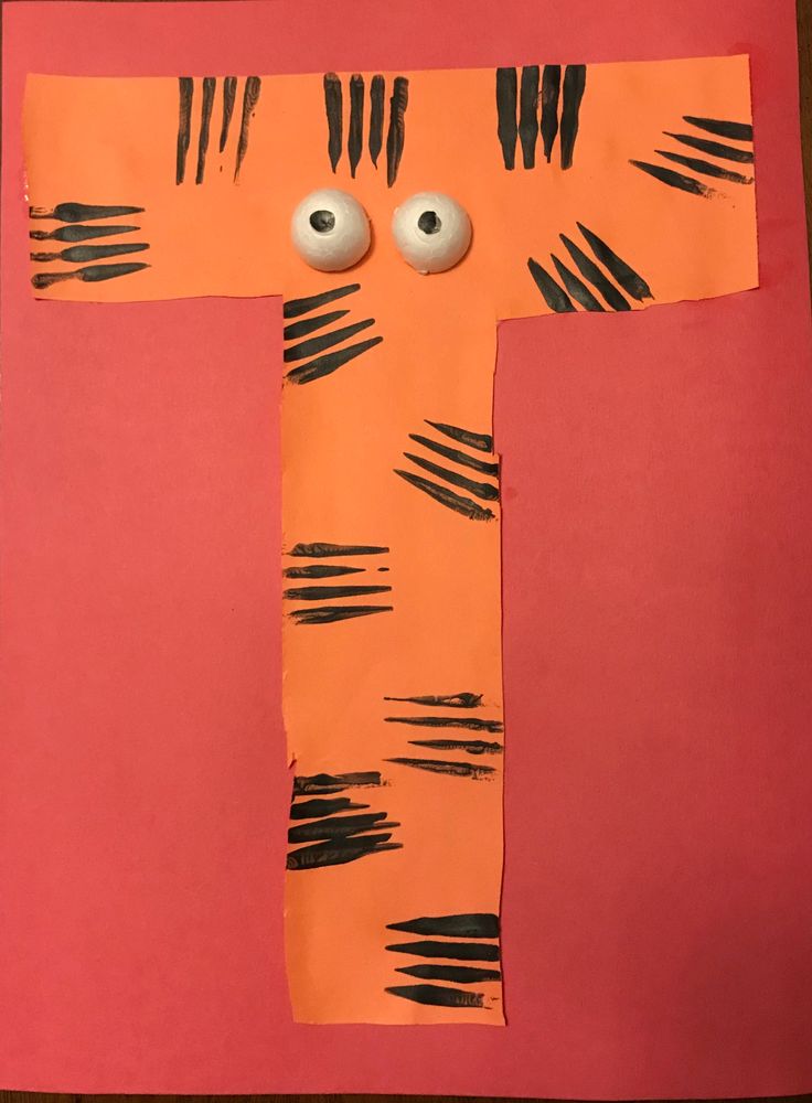 the letter t is made out of construction paper with googly eyes and black strips