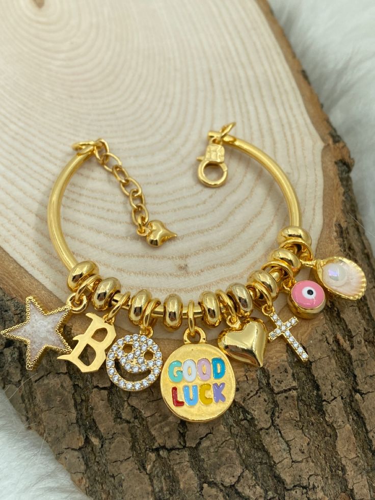 Handmade Gold Bangle For Friendship, Handmade Symbolic Charm Bracelet For Gift, Gift Name Bracelet With Charms, Customized Gold Friendship Bracelets, Friendship Gold Bracelets With Dangling Charms, Gold Bracelets With Dangling Charms For Friendship, Customized Bangle Bracelets As Gift, Adjustable Gold Bracelets With Dangling Charms, Customized Metal Bracelets For Gifts