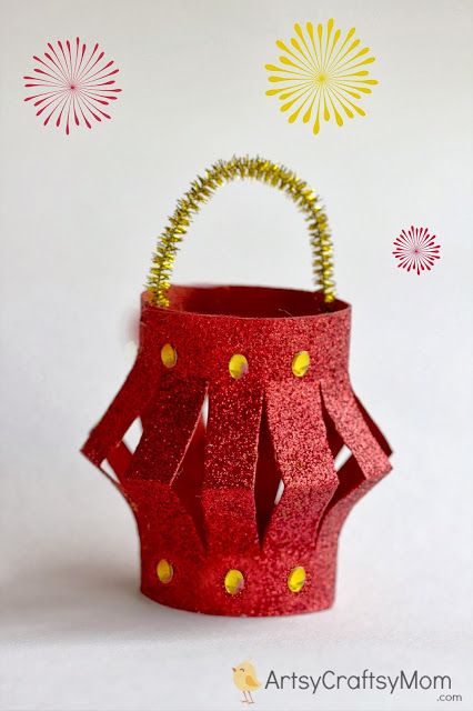 a red paper basket with gold dots on it and fireworks in the sky behind it