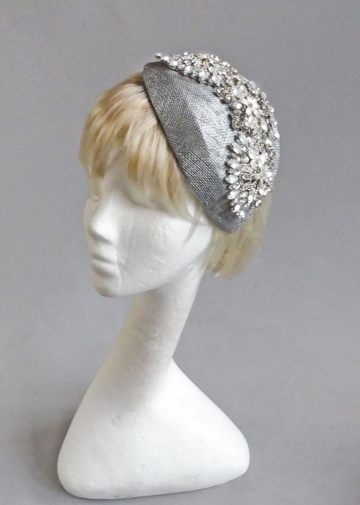 Dutch design silver sinamay with silver and white rhinestone embellishment cocktail hat on combs Fitted Silver Mini Hat For Formal Occasions, Elegant Silver Mini Hat For Formal Occasions, Elegant Silver Mini Hat For Formal Events, Silver Headpiece For Party At Royal Ascot, Silver Formal Fitted Hat, Silver Headpieces For Party At Royal Ascot, Silver Mini Hats For Royal Ascot Wedding, Silver Mini Hats For Wedding At Royal Ascot, Elegant Mini Hats With Rhinestones For Weddings