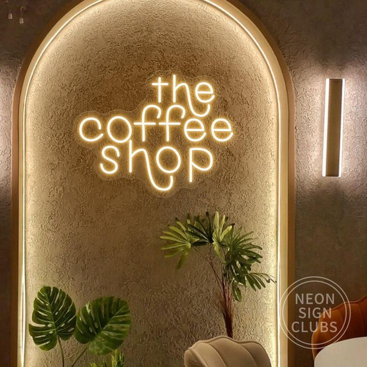 the coffee shop neon sign is lit up in front of a chair and potted plant