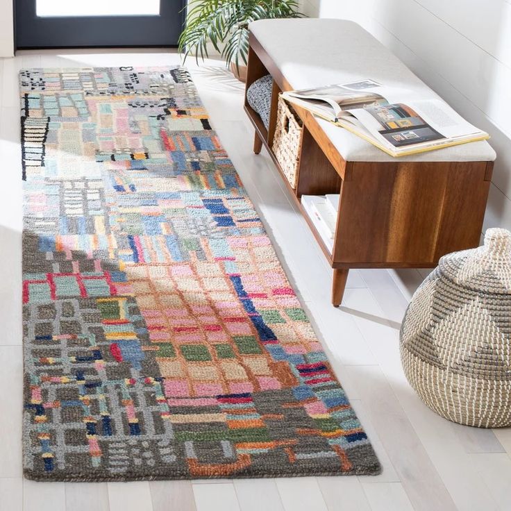 a multicolored area rug in a living room