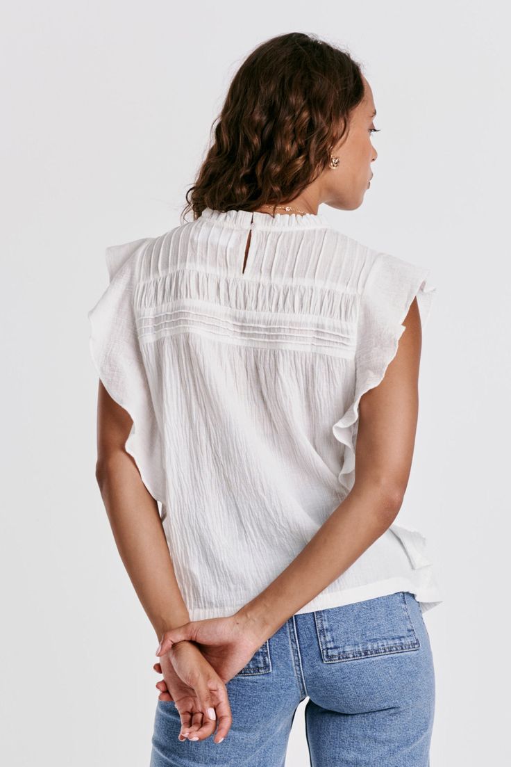 Ruffle sleeve & neck top, crew neck with back keyhole in front & back pleated yoke. Solid color woven on relaxed fit. Carefree & wholesome, stylish details embracing the essence of nature's beauty.Body length from HPS: 24 1/2", Sleeve ruffle: 3", Bust: 39" (Size Small) 100% COTTON Machine wash cold, Tumble dry low Imported Casual Cotton Flutter Sleeve Tops, Casual Cotton Tops With Flutter Sleeves, White Blouse With Relaxed Fit And Crew Neck, White Relaxed Fit Crew Neck Blouse, White Relaxed Fit Blouse With Crew Neck, White Relaxed Fit Top For Work, Casual Spring Crew Neck Blouse, White Spring Blouse For Casual Gatherings, Spring Crew Neck Blouse For Casual Gatherings