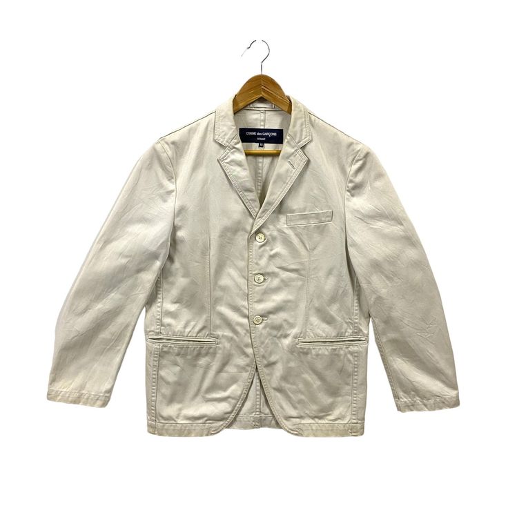 "COMME des GARCONS HOMME Jacket Comme des Garcons Three Button Blazer Cotton Jacket Japanese Fashion Designer Cream White Medium * Used item. In good condition 7/10. Minor signs of wear, light stain marks/spots. All good no defects (view photos) * AD 2006 3B Cotton Jacket. Made in Japan * Tagged size SS (equivalent to M). May fit small to medium. Flat laid measurements in inches (appox) - Chest (underarm to underarm) : 21.5\" - Length (side of neck seam to bottom hem) : 28.5\" - Shoulder (seam t Classic Spring Blazer With Buttoned Pockets, Beige Blazer With Button Closure And Suit Collar, Beige Button-up Blazer With Pockets, Beige Blazer With Pockets, Double-breasted Cotton Blazer With Buttons, Spring Button-up Blazer With Patch Pockets, Khaki Blazer With Buttoned Pockets For Work, Beige Blazer With Buttoned Pockets For Work, Business Blazer With Buttoned Pockets And Lapel Collar