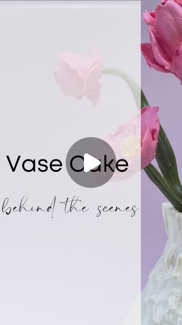 pink flowers in a white vase with the words vase cake behind it