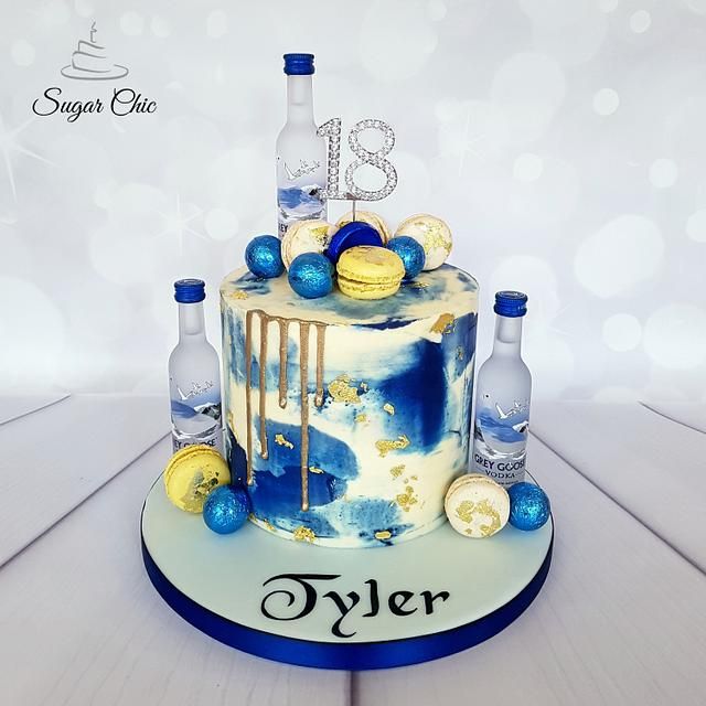 a cake with blue and gold decorations on it that reads 13 tyler, surrounded by liquor bottles