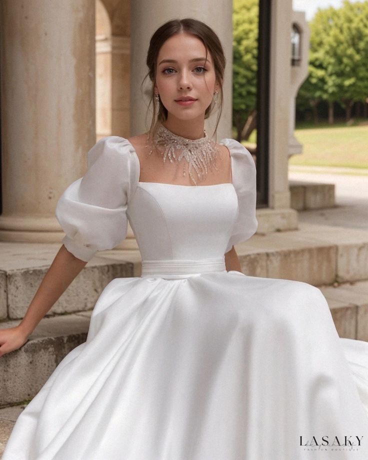 a woman in a white dress sitting on steps