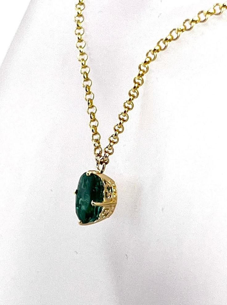 Natural, Oval Shape Green Emerald  set in 14 karat Yellow Gold Ornamental Frame and suspended from 16 inch long 10 karat Yellow Gold Rolo Chain. The Emerald weighs 2.04 carat and measures 9x7 millimeters The necklace all total weighs 2.03 grams Luxury Oval Necklace With Prong Setting, Elegant Oval Gemstone Solitaire Necklace, Formal Gold Emerald Necklace With Round Pendant, Formal Oval Gemstone Solitaire Necklace, Luxury Oval Solitaire Necklace For Formal Occasions, Timeless Oval Emerald Jewelry, Classic 14k Gold Oval Solitaire Necklace, Luxury Jewelry With Prong Setting And Oval Link, Luxury Oval Link Jewelry With Prong Setting