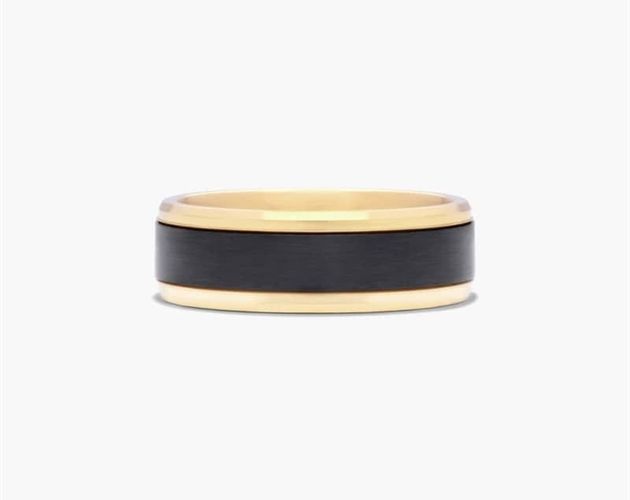 a black and gold wedding ring on a white background