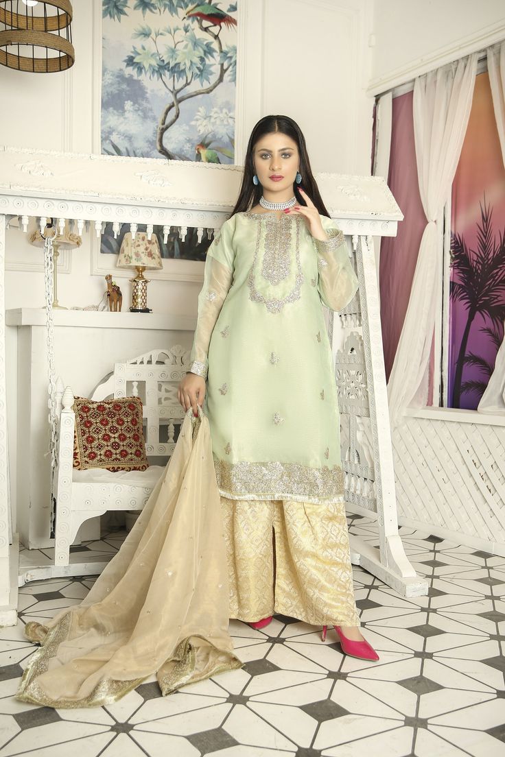 ➤ Mint green embroidered masuri organza kameez, golden jamawar Gharara, golden masuri organza dupatta | Length – Shirt Length 38"; Sharara Length 39.5" with Soft Elastic Belt; Dupatta length 2.18 m Width With Lace 0.89 m & Without Lace 0.85 m ➤ ➤ ➤ ➤ 🌸 Fabric Details - Chiffon, Organza, 🌸 Craft and Decorations - Beautiful Embroideries, embellishments, patches, and laces 🌸 Care - Hand Wash only 🌸 Length & Style - Top ~ 38 - 40 " A-Line/ kurta style, bottom trousers/gharara style, with embroid Gold Organza Lawn Suit With Dabka Work, Gold Unstitched Suit For Eid, Festive Organza Salwar Kameez For Eid, Unstitched Jamawar Lehenga For Party, Gold Anarkali Salwar Kameez In Organza, Gold Organza Kurta With Zari Work, Festive Organza Kurta For Eid, Gold Jamawar Lawn Suit For Festivals, Festive Jamawar Lehenga For Party