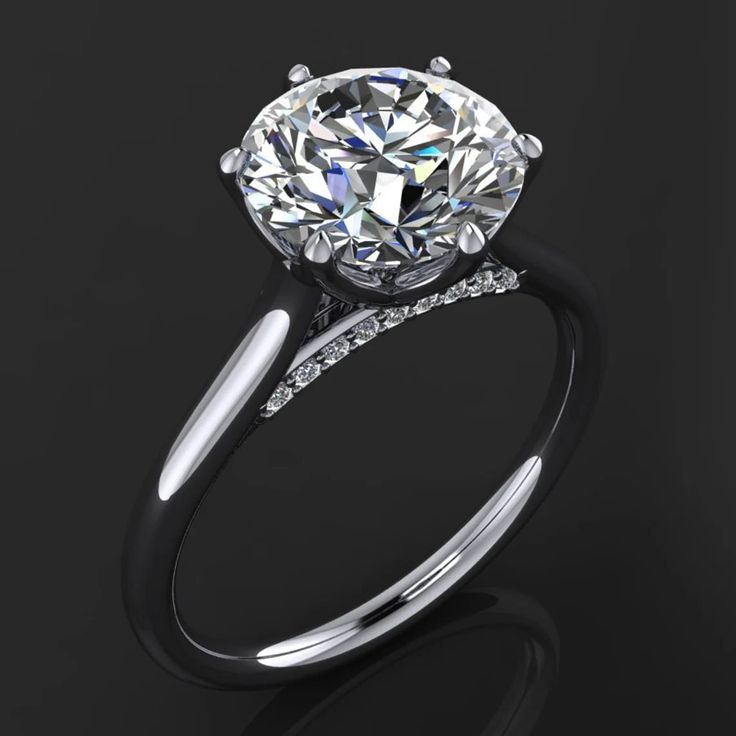 a diamond engagement ring on a black background