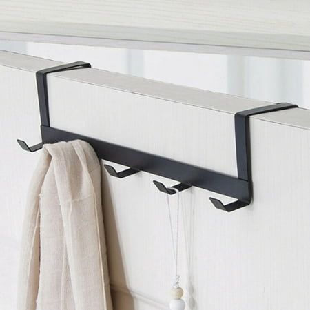 there is a towel hanging on the wall next to a coat rack with two hooks