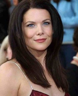 a woman with long hair and blue eyes wearing a red dress is smiling at the camera