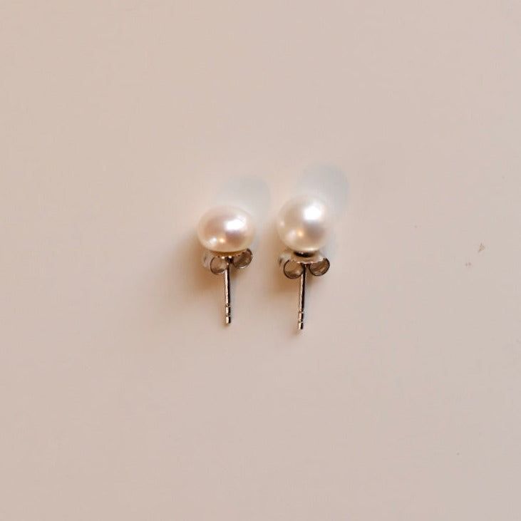 Classic, beautiful, essential, versatile... what is not to love about classic pearl stud earrings? Everyone needs to own a pair of these amazing earrings!! Now available in Round or Button pearls. (Button pearls are flat on the back) See the full explanation here: https://youtu.be/GmU0RUvXumU Choose which size you prefer and your metal, too! Cultured pearl studs... Always a classic! Here, Abby is wearing the 7mm Round studs. And here she is wearing 7mm button studs! Pearl Girls Favorite Our Pear Classic Pearl Drop Earrings, Classic Silver Pearl Earrings For Everyday, Classic Pearl Earrings As Gift, Classic Round Pearl Earrings For Everyday, Classic Pearl Earrings With Pearl Charm As Gift, Classic Pearl Charm Earrings As Gift, Classic White Pearl Earrings For Pierced Ears, Classic Pearl Charm Earrings For Gift, Classic Hypoallergenic White Gold Pearl Earrings