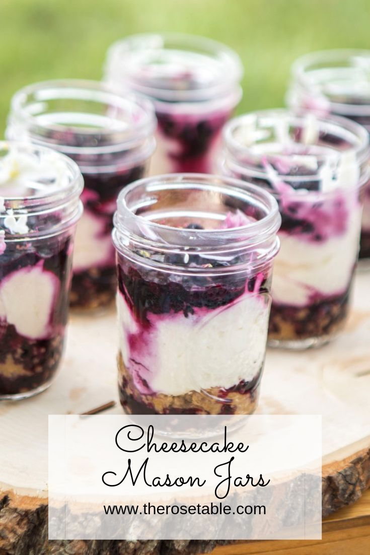 blueberry cheesecake mason jars on a wooden tray