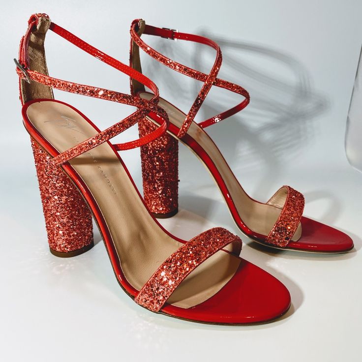 Giuseppe Zanotti Glitter Leather Sandal Womens Size 8.5 Nwt. 100% Authentic Made In Italy Color/Material: Geranium Leather (Between Pink & Red) Design Details: Sequin Glitter Details, Criss Cross Strap Buckle Closure Lightly Padded Leather Insole Smooth Leather Sole 4.5” Heel Dust Bag Msrp: $750 Party Season Glitter Accented Ankle Strap Heels, Holiday Evening Sandals With Round Toe, Holiday Ankle Strap Heels With Glitter Accents, Luxury Glitter Sandals For Formal Occasions, Luxury Formal Sandals With Glitter, Glitter Accents Sandals For Prom, Glitter Accented Sandals For Prom, Glamorous Glitter Sandals For Formal Occasions, Glamorous Red Open Heel Heels