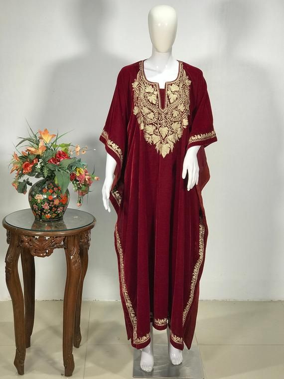 A stunningly marvellous Kaftan. This Kaftan features Kashmir tilla embroidery all around the kaftan borders.- - - - - - - - - - - - - - - - - - - - Product Details- Condition: Brand New (made to order)- Style: Kaftan- Fabric: Fine Micro Velvet- Base Colour: Red- Embroidery: Tilla Work- Embroidery Colour: Gold- Standard Length: 42" - Care Instructions: Dry Clean Only**If you want the kaftan to be shorter or longer, just send us a message, and we will tailor it accordingly.Sizing- Please select yo Gold Bohemian Dress With Resham Embroidery, Long Kaftan With Gold Embroidery For Festivals, Bohemian Kaftan With Gold Embroidery For Festive Occasions, Festive Red Abaya With Dabka Detailing, Red Embroidered Maxi Length Kurta, Festive Red Abaya With Dabka, Festive Bohemian Kaftan With Gold Embroidery, Long Kaftan With Gold Embroidery For Festive Season, Traditional Festive Kaftan With Gold Embroidery