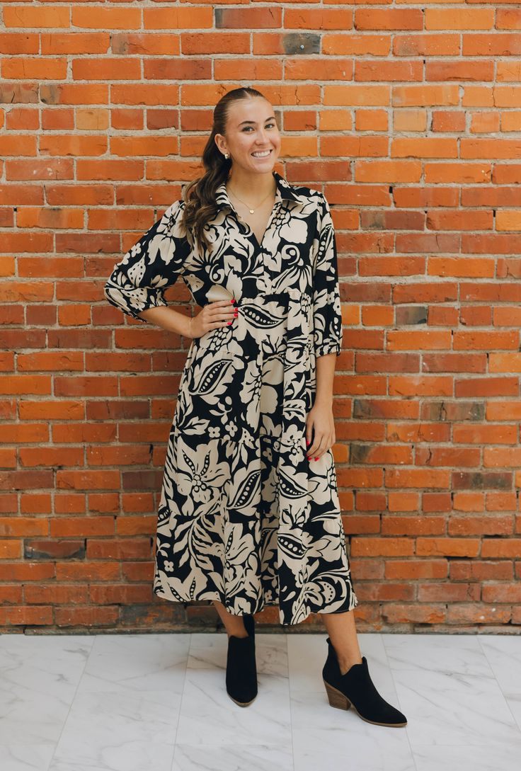 This Umgee dress is the perfect blend of style and comfort. Featuring a mixed print, a tiered midi skirt, and a V neckline , this dress is sure to stand out. It has a soft, lightweight fabric and designed with long sleeves, it's perfect dress to wear during the transitional part of the seasons. Printed Midi Dress For Brunch, Printed Midi Dress For Day Out, Printed Mid-length Midi Dress For Vacation, Printed Midi Dress For Vacation, Tiered Skirt Midi Dress For Brunch, Flowy Printed Midi Dress, Printed Flowy Midi Dress, Black Tiered Skirt Dress For Brunch, Black Tiered Skirt Dress For Day Out