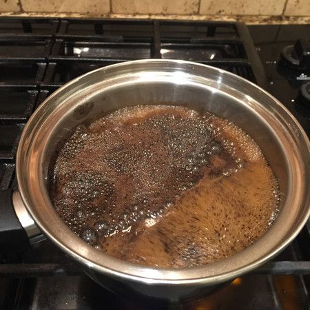 a pot filled with liquid sitting on top of a stove