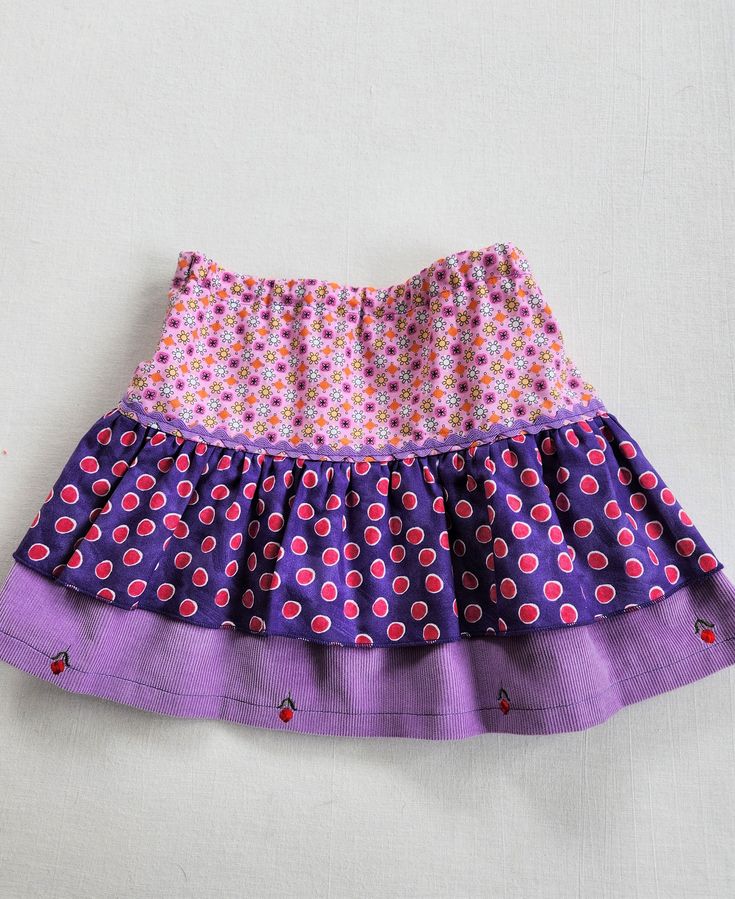 Cotton tiered skirt with rick rack trim. Tiers are purple and pink cotton prints and purple embroidered corduroy. -This is a size 3 skirt. -measures approx 11 inches long. -100% cotton -All seams are professionally finished. -Made in smoke free environment. * Care Machine wash in cold water Machine dry cool or line dry. Touch up with an iron if needed. **CUSTOM ORDERS** Every item in the shop is one of a kind (OOAK) **If you see something you like, but it's not the size that you need...let us kn Cute Cotton Ruffle Skirt, Cute Cotton Ruffled Skirt, Cute Cotton Skirt With Ruffles, Cute Tiered Cotton Skirt, Cute Cotton Tiered Skirt, Cute Cotton Mini Skirt, Cute Fitted Cotton Skirt, Cute Cotton Lined Skirt Bottoms, Cute Cotton Lined Skirt