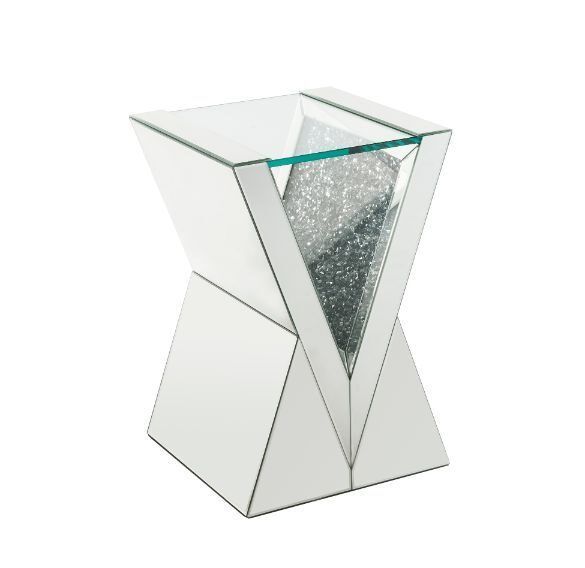 a glass table with silver glitter in the center and an upside down mirror on top