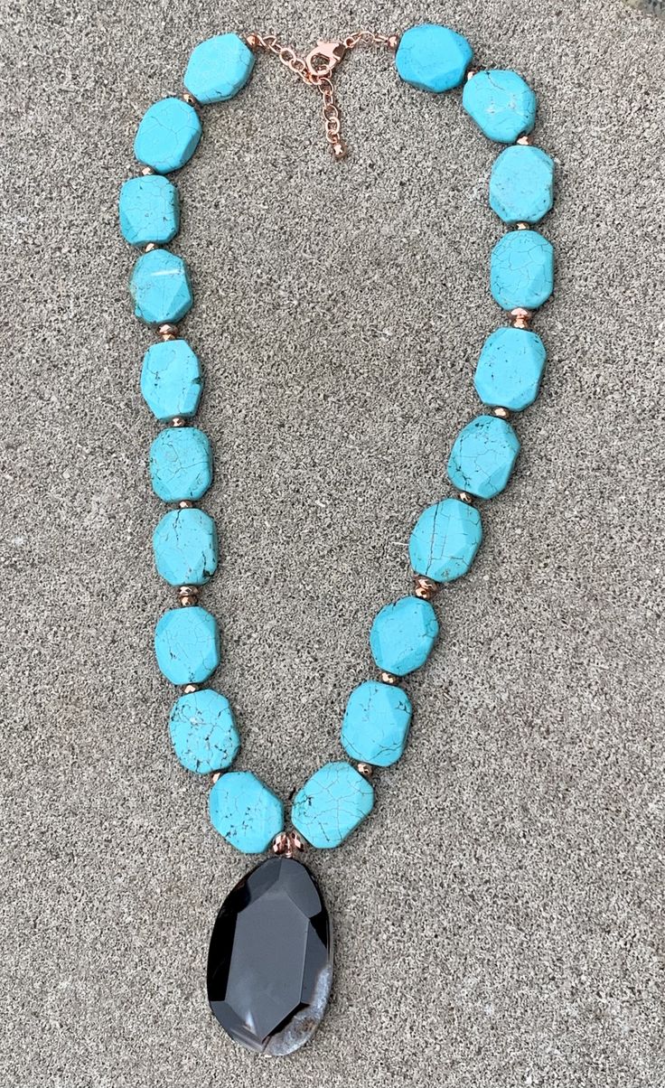 Back to Blue Turquoise Magnesite & Agate Pendant Necklace Barse Genuine Agate Genuine Turquoise Magnesite Genuine Hematite & Copper Genuine Bronze Lobster Clasp Closure Crafted and Finished By Hand CCRUN03MUC Approximate Measurements: Length- 16"-18"+ 2" Extender; Pendant Slab Slice- 1 3/4" Live your life in color with this beautiful statement pendant necklace. Pair this with a simple white V-neck t-shirt, white jeans, a denim jacket and you will be ready for a night out on the town with Blue Chrysocolla Necklace With Stones, Turquoise Agate Gemstone Beads Necklace, Agate Turquoise Necklace With Gemstone Beads, Turquoise Chrysocolla Gemstone Beads Necklace, Blue Turquoise Necklace With Large Teardrop Stone, Turquoise Agate Gemstone Beaded Necklaces, Turquoise Chrysocolla Stone Necklaces, Turquoise Agate Beaded Necklace, Turquoise Agate Beaded Necklace With Gemstones