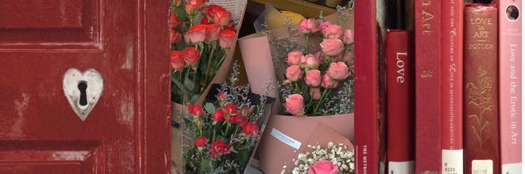 a red door with books and flowers on it's side, in front of a bunch of pink roses