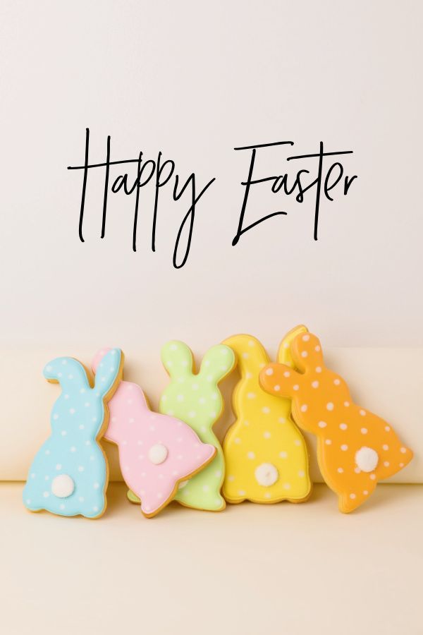 three decorated cookies sitting next to each other on top of a white surface with the words happy easter written in black