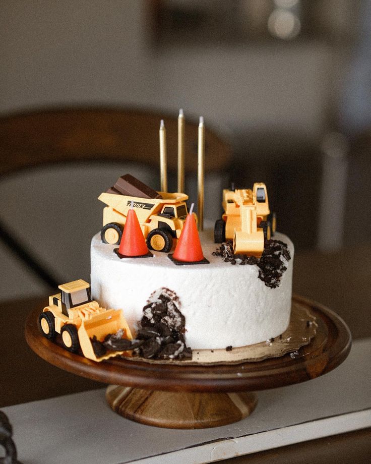 a birthday cake with construction trucks on it