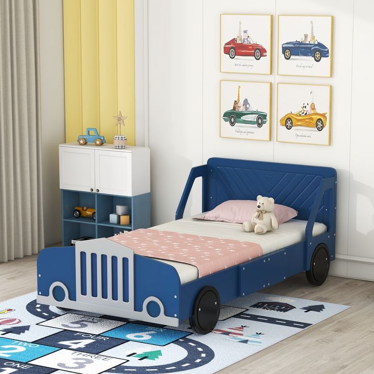 a child's bedroom with a blue bed and toy cars on the rugs