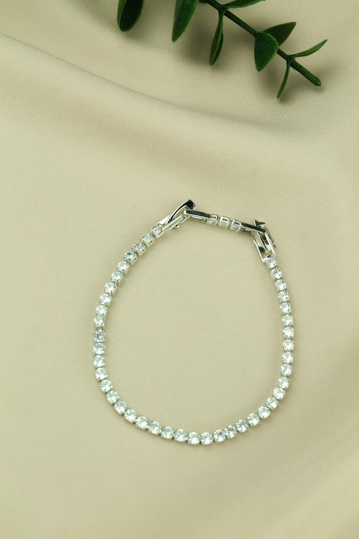 This elegant stainless steel bracelet combines durability with sophistication. Perfect for daily wear, it stands out with its unique design. With its minimalist and modern design, it complements any outfit perfectly. Comes in a beautiful gift package. Minimalist Round Stainless Steel Bracelets, Dainty Stainless Steel Jubilee Bracelet, Elegant Stainless Steel Charm Bracelet With Adjustable Chain, Minimalist Cubic Zirconia Bracelets For Party, Silver Tennis Bracelet Bangle, Minimalist White Gold Bracelets For Party, Elegant Stainless Steel Charm Bracelet, Classic Wedding Bracelet Stainless Steel, Elegant Stainless Steel Bangle Charm Bracelet