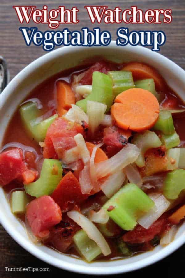 a bowl of soup with carrots, celery and other vegetables in it