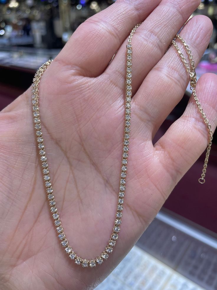 "Beautiful Genuine Diamond Necklace. Perfect piece for a bit of bling around the neck. Wear on its own or layer with other necklaces. Excellent craftsmanship, the diamonds are set nice and smooth. Simple and stylish necklace to wear with everything. 14K Chain has extra loop so you can wear at 18\", 17\", or 16\" lengths. About 2.5mm width. Only yellow gold available now. Genuine earth mined round brilliant cut diamonds Total weight: 1.52 carats Clarity: SI/I Color: G Solid 14K white (sold out) 1 Classic Cubic Zirconia Necklace With Bling, Classic Cubic Zirconia Necklaces With Bling, Classic Diamond Necklace With Bling, Diamond White Round Tennis Necklace With Bling, Gold Crystal Tennis Necklace For Wedding, Diamond White Bling Tennis Necklace, Gold Bling Tennis Necklace For Gift, Gold Tennis Necklace With Prong Setting As Gift, Gold Crystal Jewelry With Prong Setting