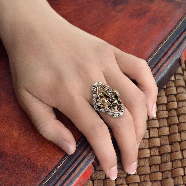 "If you were an American in Paris in the '50s, you might have taken a fancy to Francophile fashion baubles such as this elegant antique ring. Mixed metal finishes in burnished silver-tone and bronze-tone, in combination with all the elements and textures, give off the look of vintage luxury. Smoke crystal adds drama. Comfortable band shank adjusts to fit sizes 6 - 9. Burnished bronze metal finish. Size: 1.5\" L x 1\" W, Adjustable band Signed and copyrighted Sweet Romance. Made in our Los Angele American In Paris, An American In Paris, Paris Jewelry, Antique Ring, Sweet Romance, Ring Antique, Bronze Metal, Vintage Ring, Metal Finishes