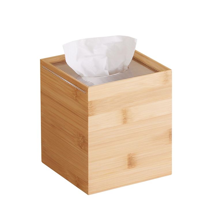 a tissue dispenser made out of bamboo with a white paper towel in it