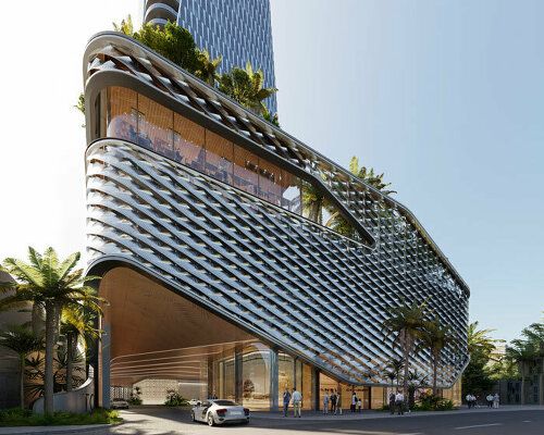 an architecturally designed building on the corner of a street in front of palm trees